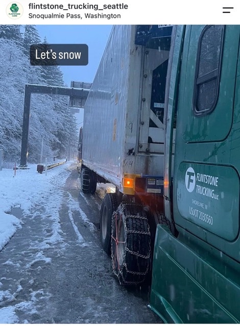 Flintstone Trucking truck driving on a snowy mountain road