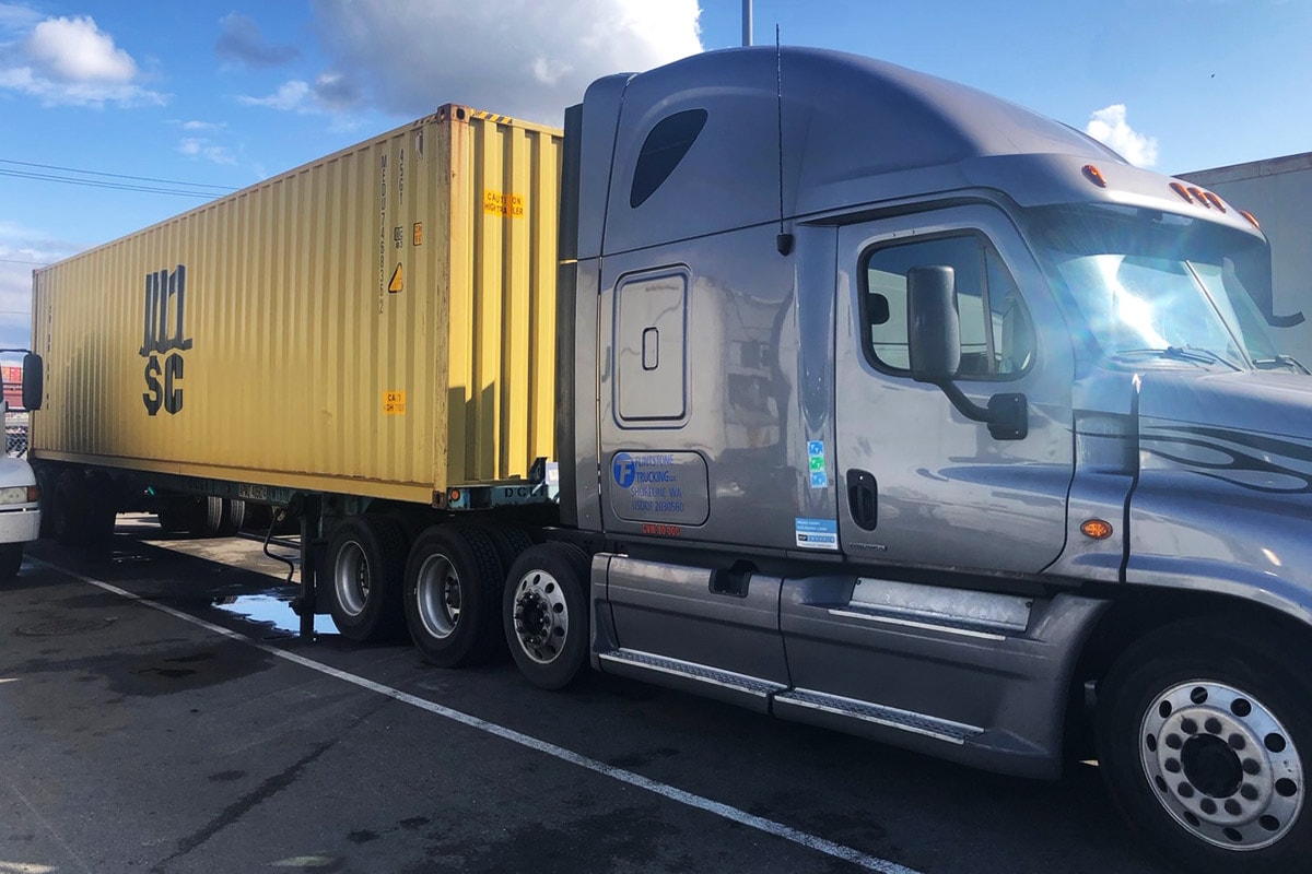 Flintstone Trucking blue truck at a Seattle loading dock