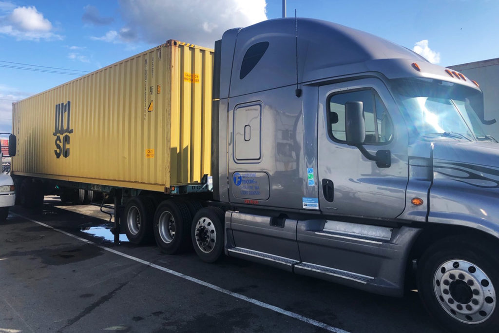 Flintstone Trucking semi truck hauling a container in Seattle